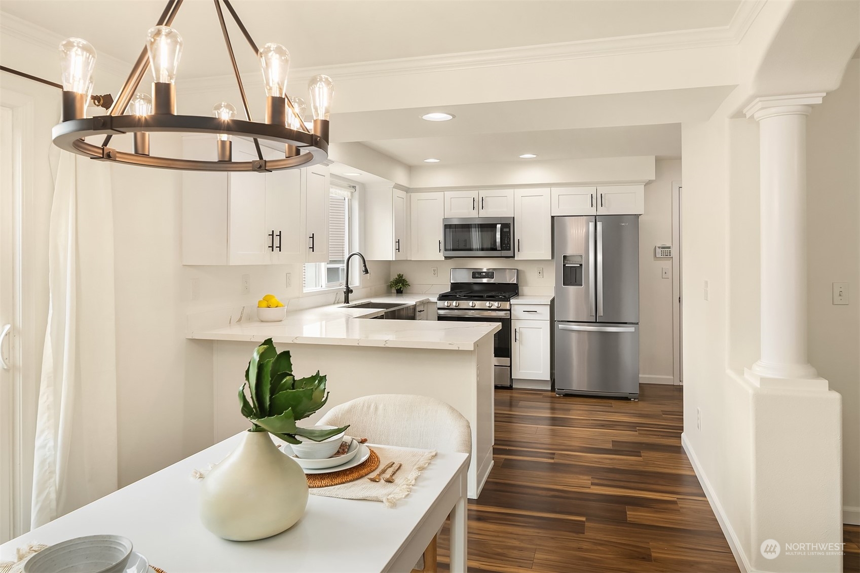 3410 189th Street Southeast Bothell, WA 98012 - Photo 8 of 23 a kitchen with stainless steel appliances a white refrigerator a stove a microwave and a dining table
