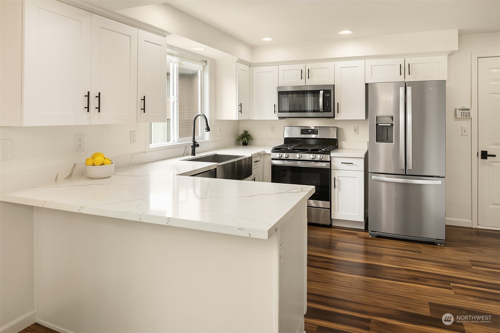 3410 189th Street Southeast Bothell, WA 98012 - Photo 9 of 23 a kitchen with a sink a refrigerator and a stove top oven