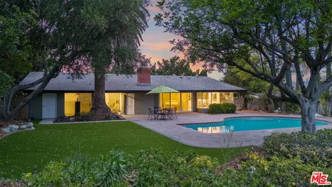 a view of a house with garden and a swimming pool