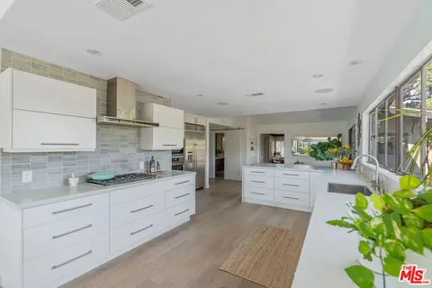 a bedroom with a bed and a potted plant