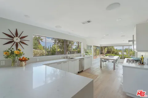 a view of patio with chairs and table under an umbrella