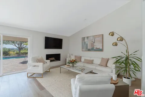 a large white kitchen with a large window