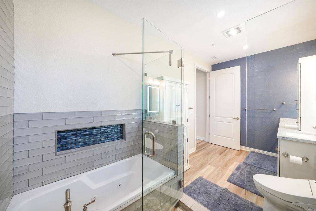 22963 Stokes Road Ramona, CA 92065 - Photo 38 of 57 a spacious bathroom with a tub shower and mirror
