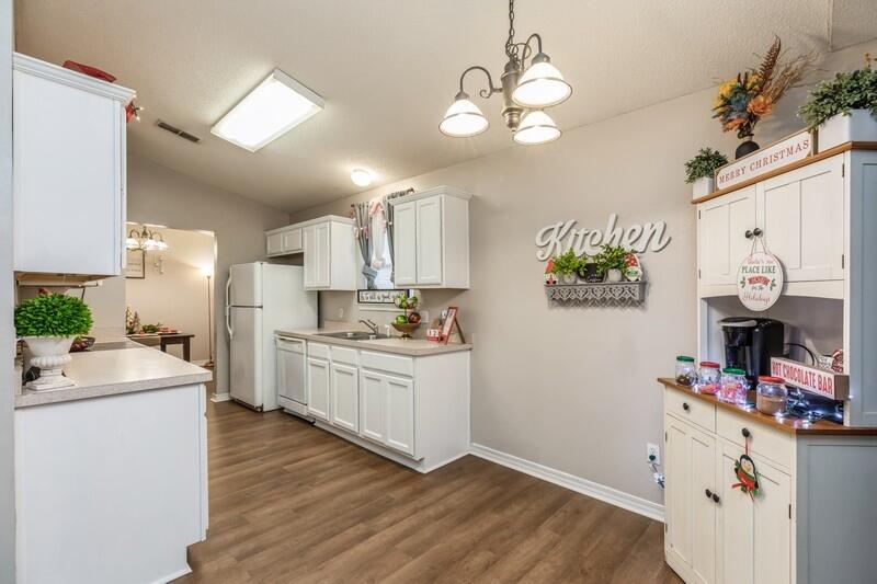 264 Limestone Circle Crestview, FL 32539 - Photo 14 of 38 a kitchen that has a lot of cabinets and wooden floor