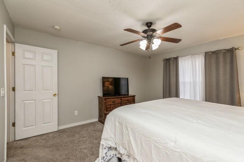 264 Limestone Circle Crestview, FL 32539 - Photo 20 of 38 a bedroom with a bed and a chandelier