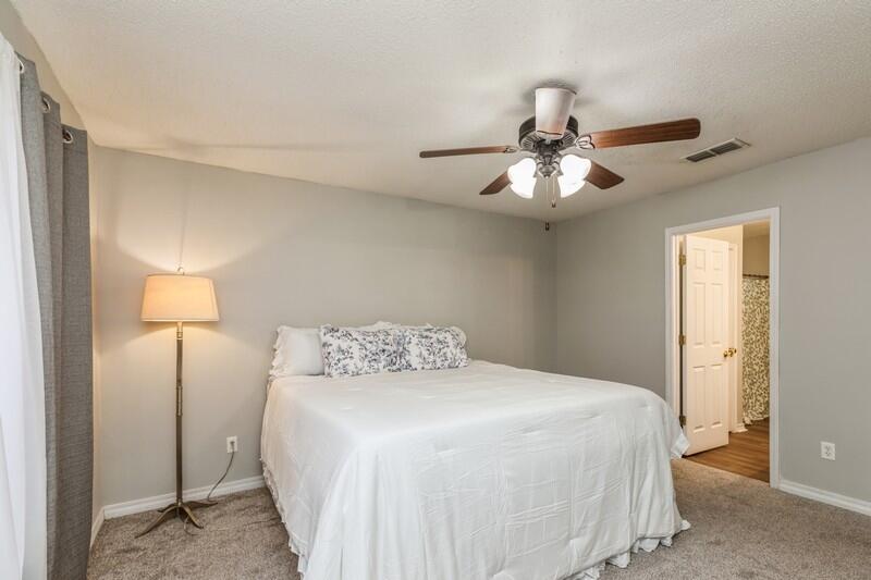 264 Limestone Circle Crestview, FL 32539 - Photo 21 of 38 a bedroom with a bed and a chandelier