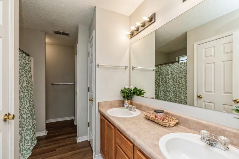 264 Limestone Circle Crestview, FL 32539 - Photo 24 of 38 a bathroom with a granite countertop sink and a mirror