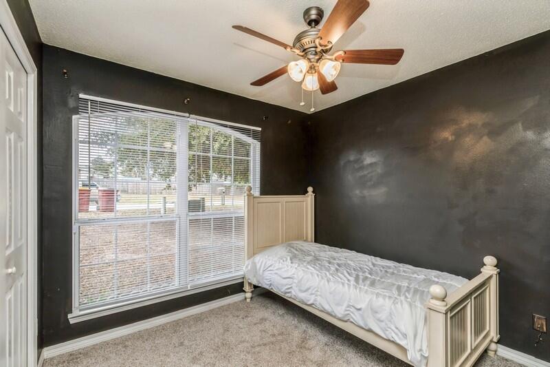 264 Limestone Circle Crestview, FL 32539 - Photo 25 of 38 a bedroom with a large bed and a chandelier