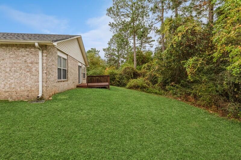 264 Limestone Circle Crestview, FL 32539 - Photo 34 of 38 a view of a house with backyard and garden