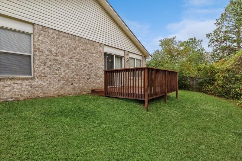 264 Limestone Circle Crestview, FL 32539 - Photo 35 of 38 a view of a backyard with plants and a garden