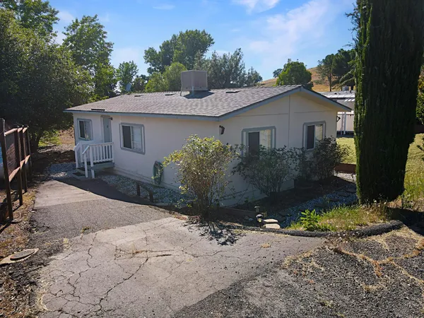 a view of a house with yard and a garden