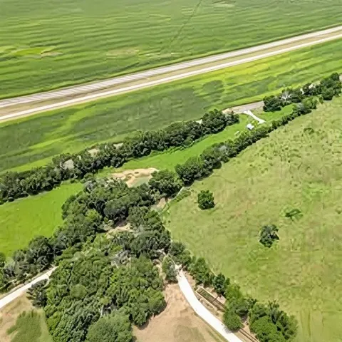 a view of a field with an ocean view