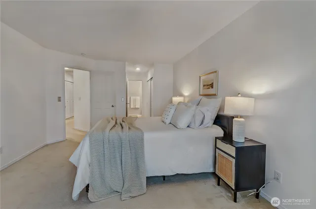 a bed room with a bed and a lamp