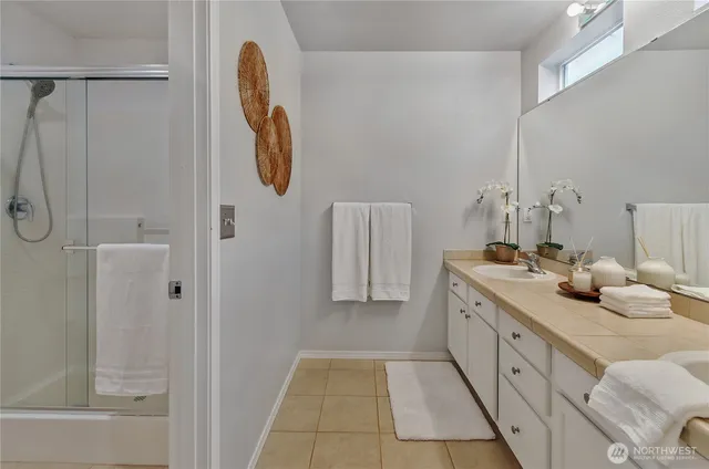 a bathroom with a tub sink and mirror