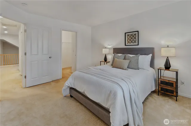 a bedroom with a bed and lamp