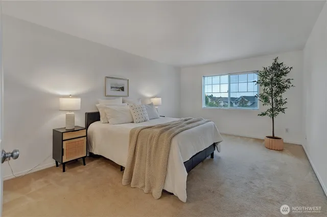 a spacious bedroom with a bed and a window