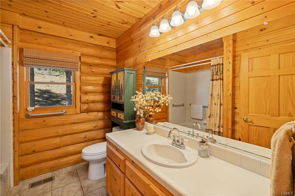 52815 Timberview Road North Fork, CA 93643 - Photo 26 of 75 a bathroom with a sink a toilet and shower
