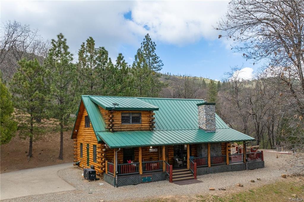 52815 Timberview Road North Fork, CA 93643 - Photo 33 of 75 a view of a chairs and table in the back yard of the house