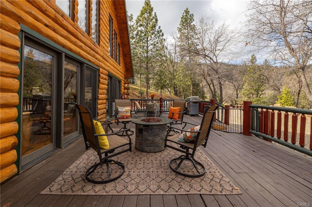52815 Timberview Road North Fork, CA 93643 - Photo 41 of 75 a view of a patio with table and chairs and wooden floor