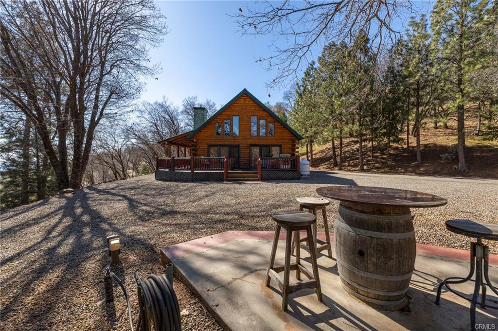 52815 Timberview Road North Fork, CA 93643 - Photo 53 of 75 a patio with table and chairs with wooden floor and fence