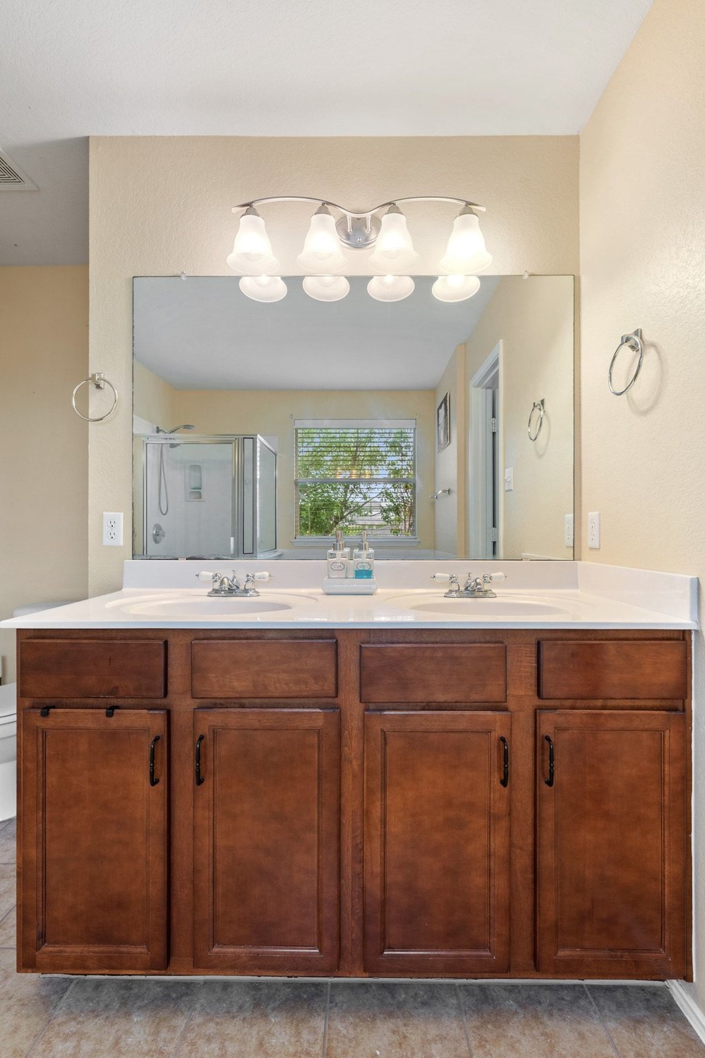 140 Wolfberry Path Buda, TX 78610 - Photo 26 of 35 a bathroom with a sink mirror and wooden floor