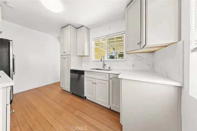 a kitchen with cabinets a sink and appliances