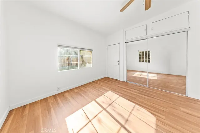 a bathroom with a granite countertop bathtub sink vanity mirror and toilet