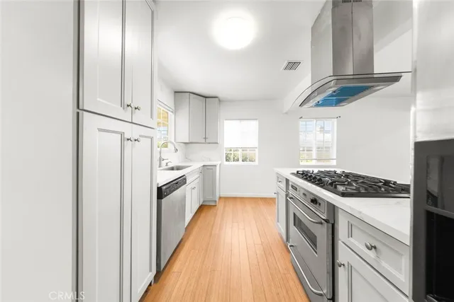 a kitchen with appliances cabinets and a sink