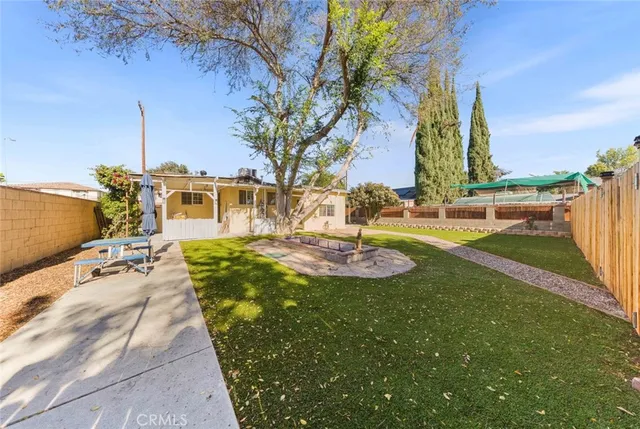 a view of a backyard with plants and patio