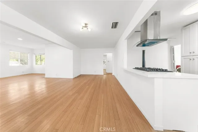 a very nice looking room with wooden floor and a ceiling fan