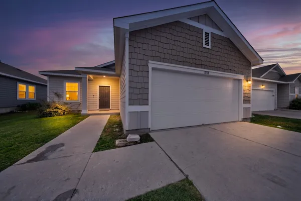 a front view of a house with a yard and garage