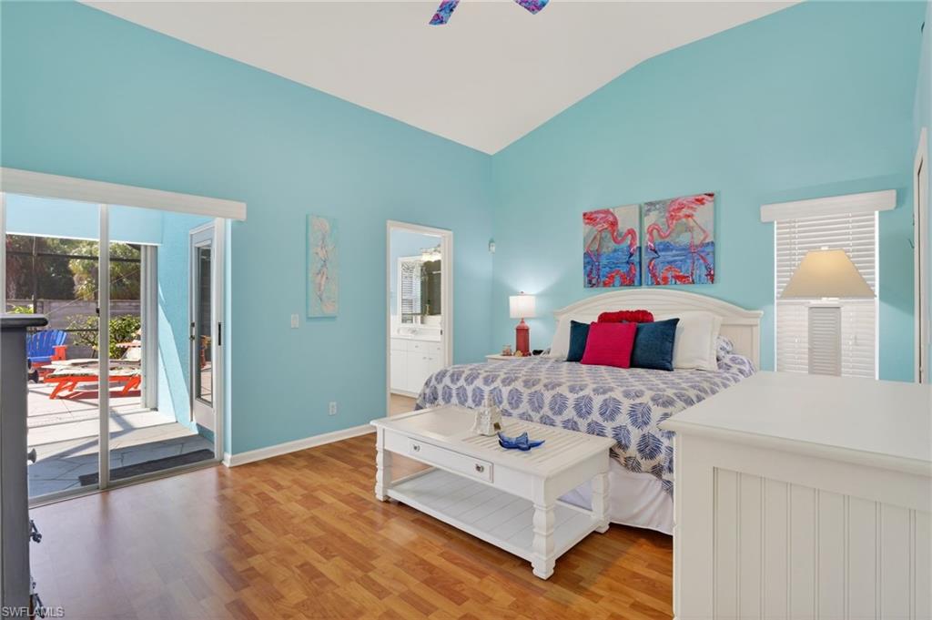 22818 Snaptail Court Estero, FL 33928 - Photo 11 of 37 a bedroom with a bed and dresser with wooden floor