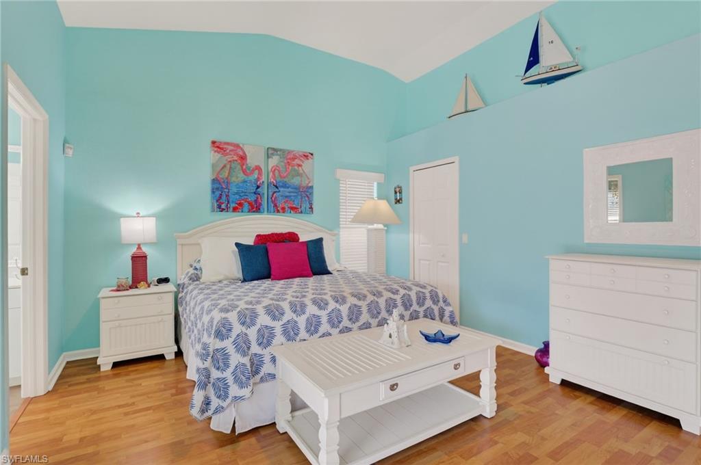 22818 Snaptail Court Estero, FL 33928 - Photo 12 of 37 a bedroom with a bed and wooden floor