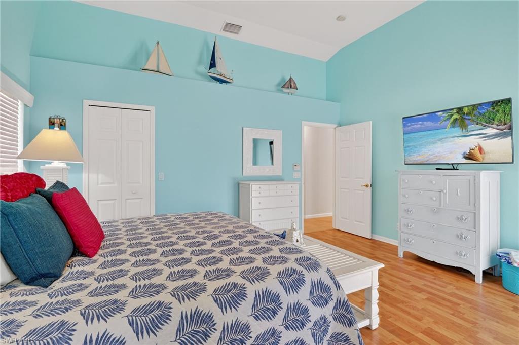 22818 Snaptail Court Estero, FL 33928 - Photo 13 of 37 a bedroom with a bed and wooden floor