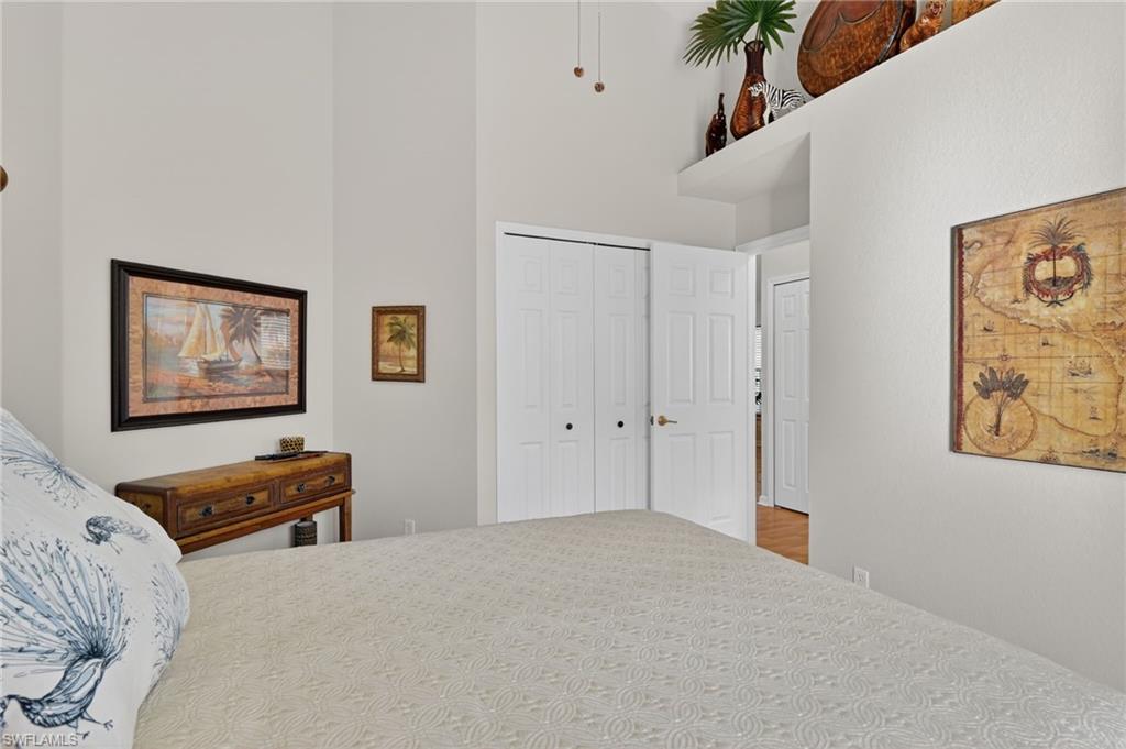 22818 Snaptail Court Estero, FL 33928 - Photo 18 of 37 a bedroom with bed and furniture