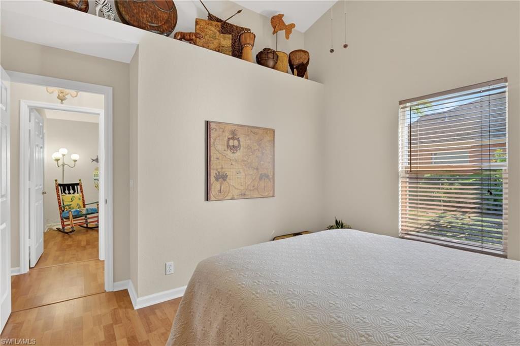 22818 Snaptail Court Estero, FL 33928 - Photo 19 of 37 a bedroom with a bed and a large window