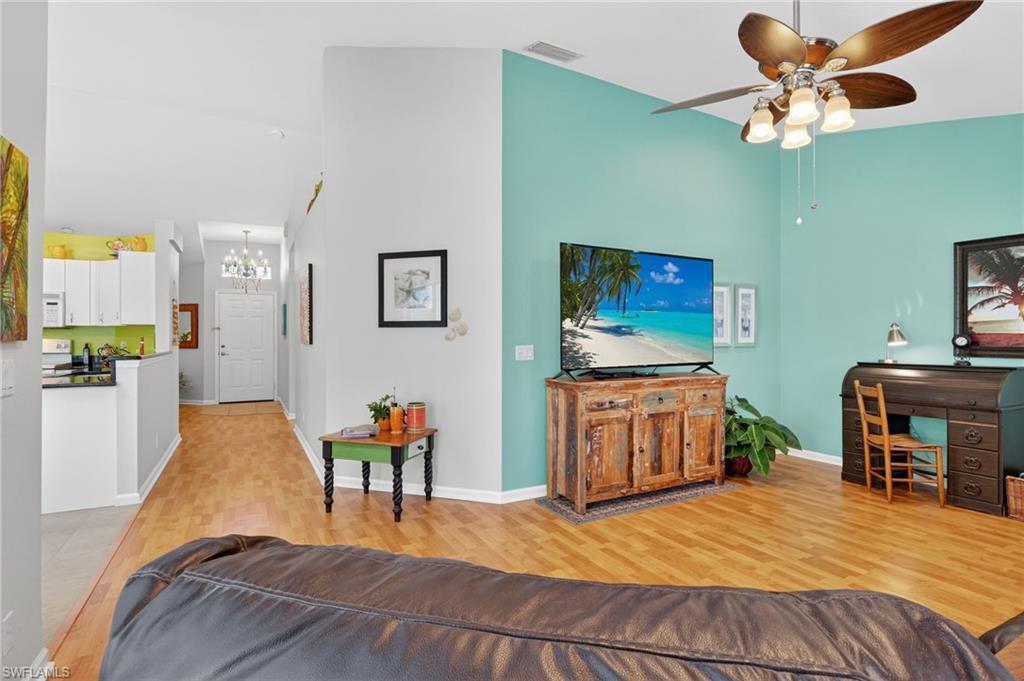 22818 Snaptail Court Estero, FL 33928 - Photo 23 of 37 a bedroom with a bed and a chandelier