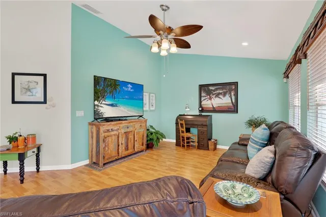 a kitchen that has a lot of cabinets in it and wooden floor