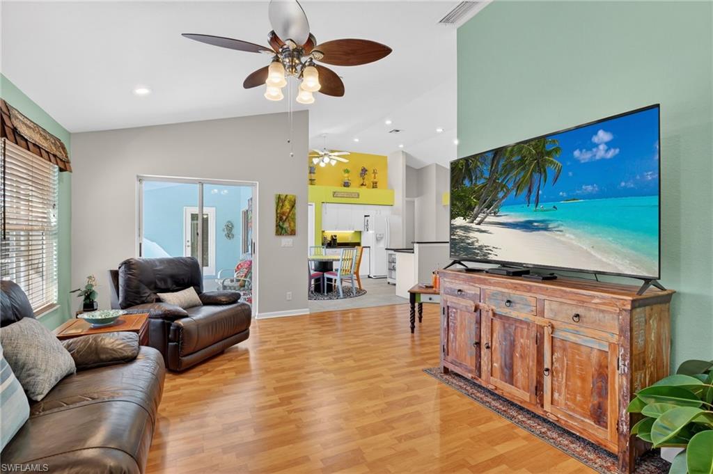 22818 Snaptail Court Estero, FL 33928 - Photo 25 of 37 a living room with furniture and a flat screen tv