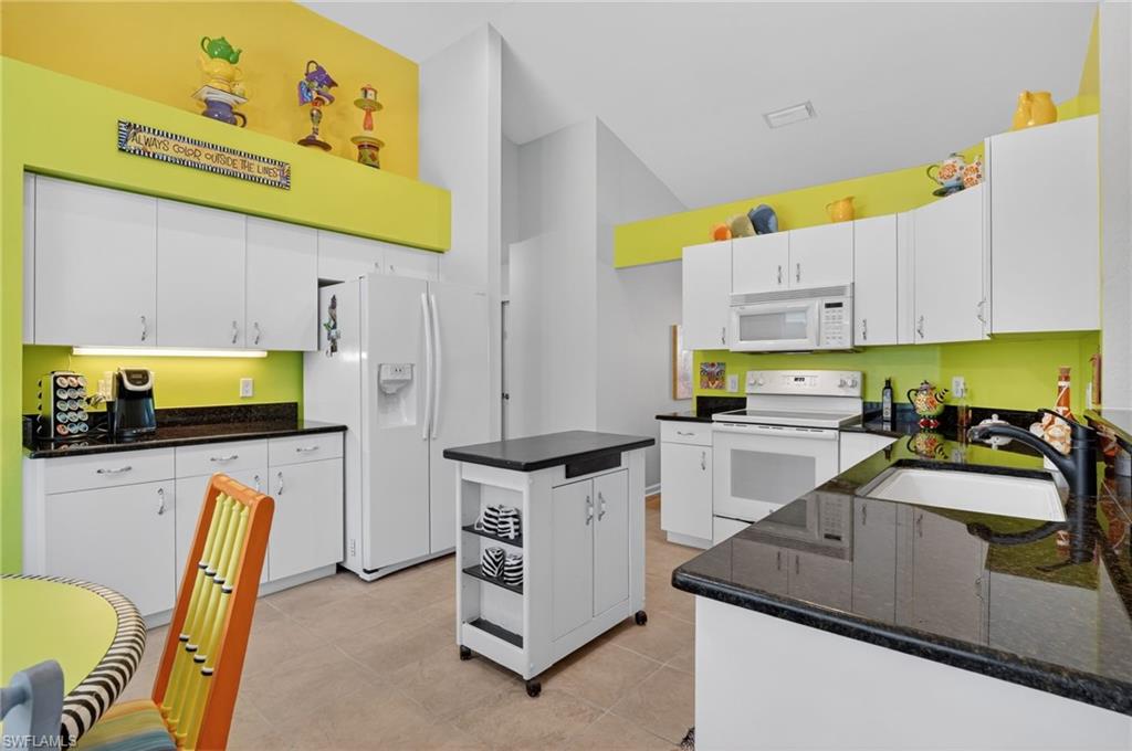 22818 Snaptail Court Estero, FL 33928 - Photo 27 of 37 a kitchen with a sink appliances and cabinets