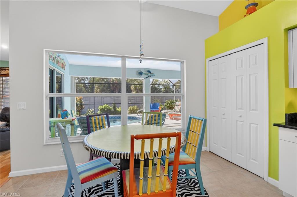 22818 Snaptail Court Estero, FL 33928 - Photo 29 of 37 a dining room with furniture a rug and a painting