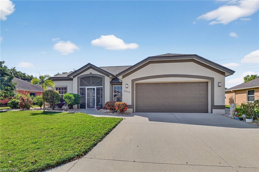 22818 Snaptail Court Estero, FL 33928 - Photo 3 of 37 a front view of a house with a yard and garage