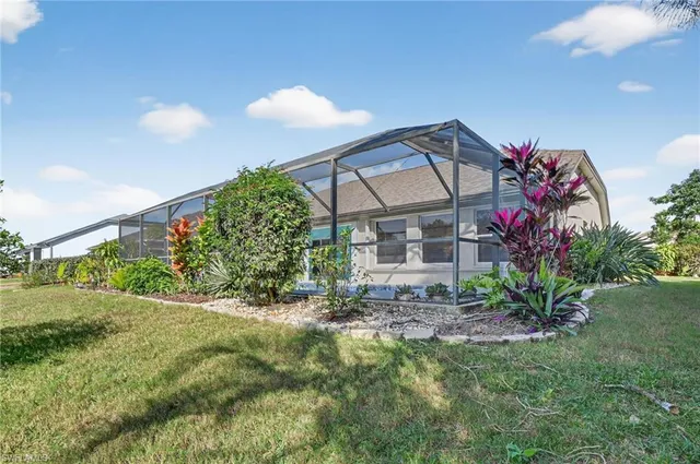 a view of a house with a yard and plants