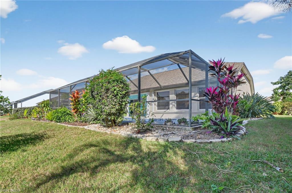 22818 Snaptail Court Estero, FL 33928 - Photo 33 of 37 a view of a house with a yard and garden