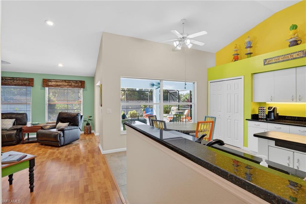 22818 Snaptail Court Estero, FL 33928 - Photo 36 of 37 a living room with furniture a flat screen tv and large windows