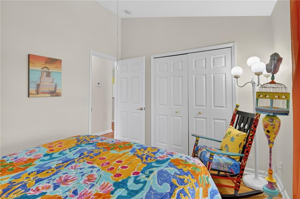 22818 Snaptail Court Estero, FL 33928 - Photo 5 of 37 a bedroom with a bed and a lamp on the dresser