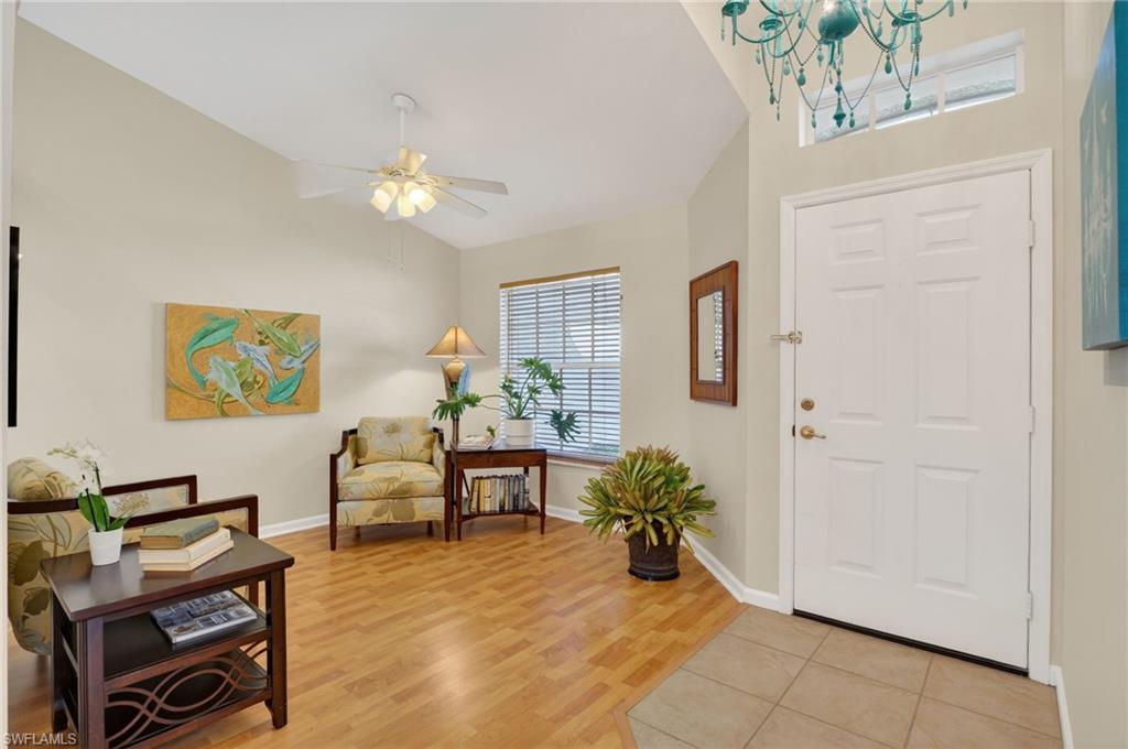 22818 Snaptail Court Estero, FL 33928 - Photo 7 of 37 a view of a livingroom with furniture and a potted plant