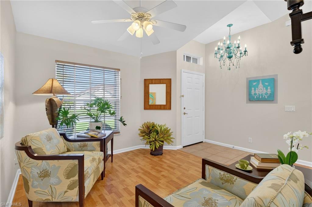 22818 Snaptail Court Estero, FL 33928 - Photo 9 of 37 a living room with furniture chandelier and a window