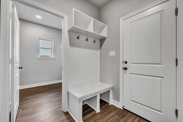 a room with a wooden floor and white walls