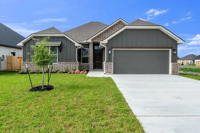 a front view of a house with a yard and porch